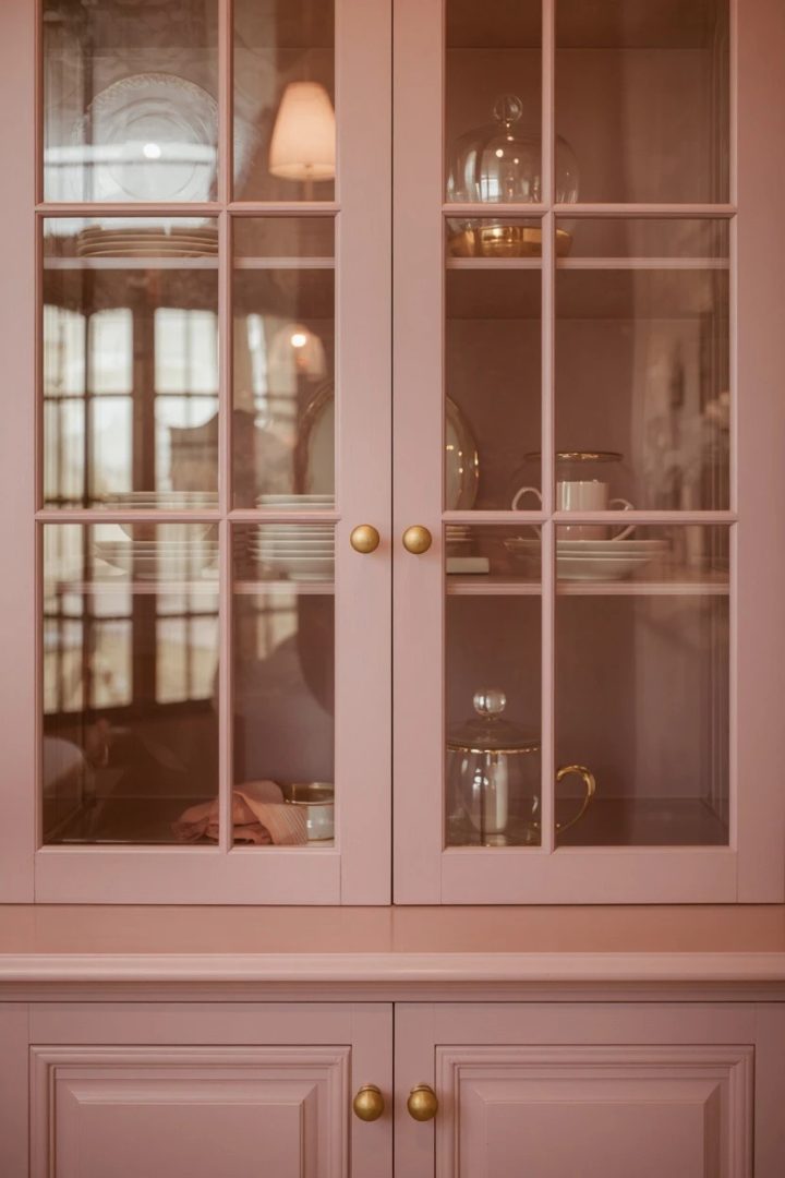 15. Make Glass Cabinets Shine with Dusty Rose and Champagne Gold