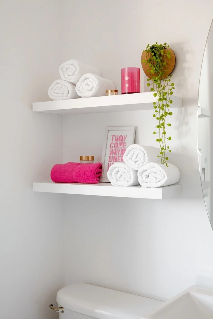 10. White Floating Shelves Styled With Pink Accents
