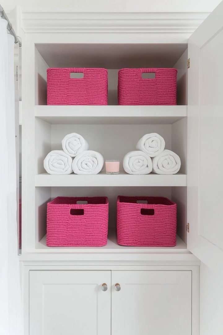 25. White Built-In Shelving With Pink Storage Baskets