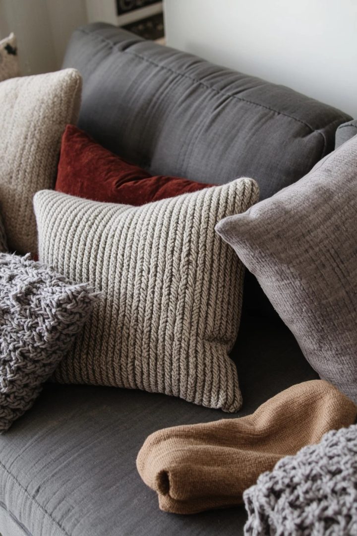 grey settee layered with textured patterned cushions
